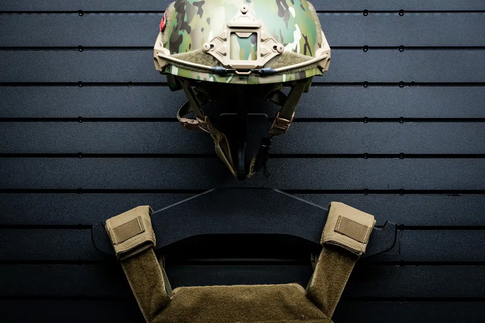 ModWall Helmet Hanger Wall mounted helmet hanger on ModWall panel beside other gear.