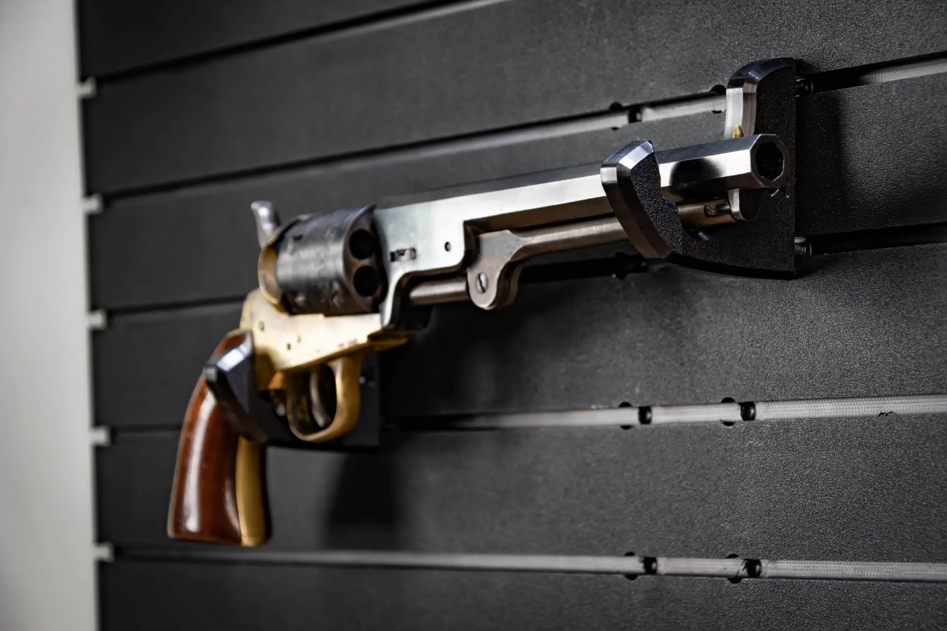 ModWall Handgun Rack Wall mounted handgun rack securing a full size pistol on panel.