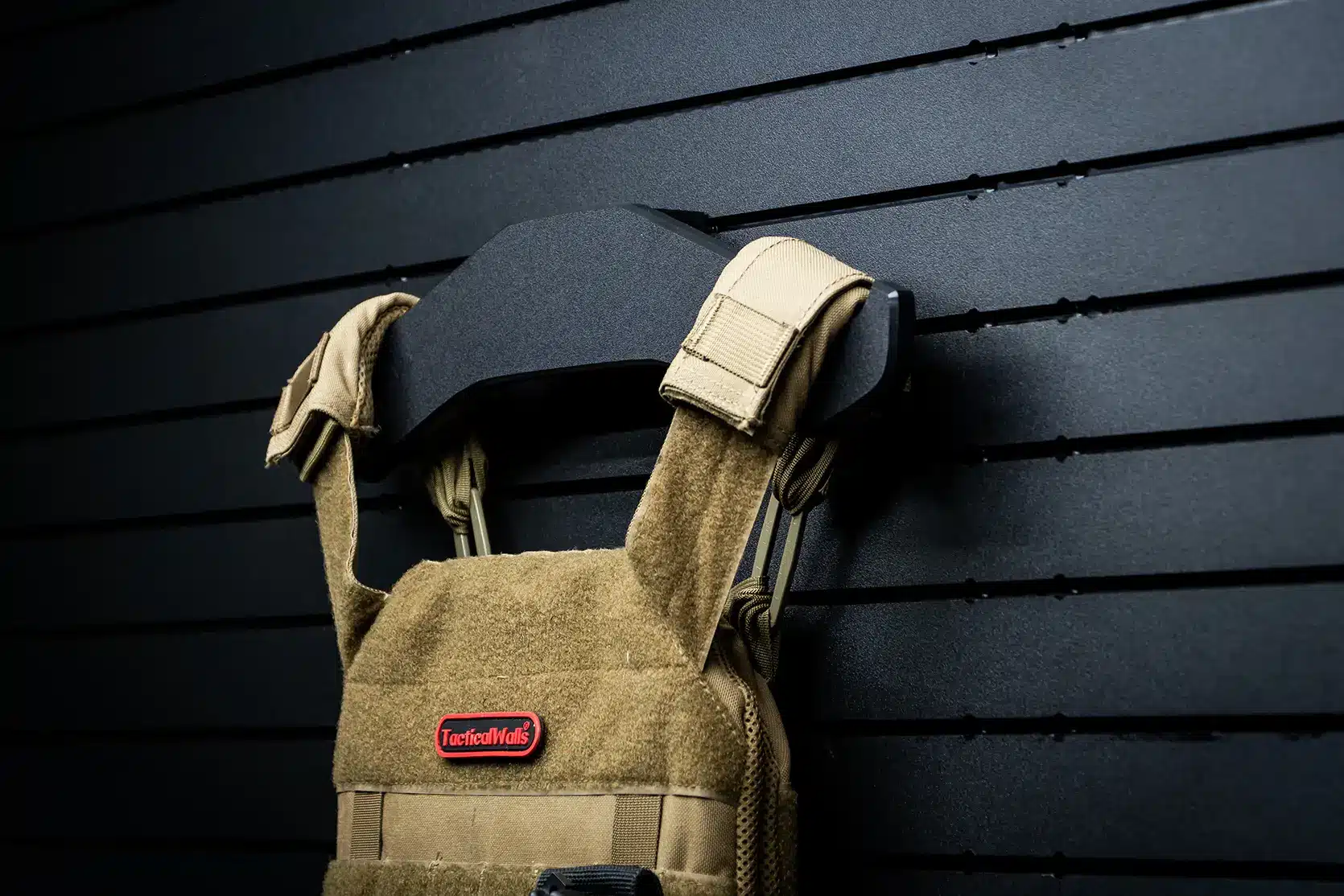 A closeup of the ModWall Tactical Vest Hanger, showcasing it's clean, durable design mounted on a ModWall Panel.