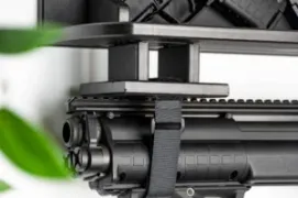 A 4x4 velcro strap block holding the barrel of a long gun securely against a ModWall shelf.