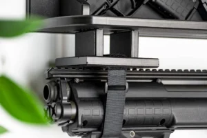 A 4x4 velcro strap block holding the barrel of a long gun securely against a ModWall shelf.