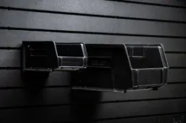 Two black Uline bins mounted on a wall panel showcasing flexible bin sizing.