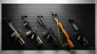 Various long guns mounted diagonally with the side profile facing outwards on the ModWall panel, showing the versatility of the Sideways Vertical Rifle Racks.
