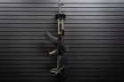 A single rifle vertically mounted on a black ModWall panel system.