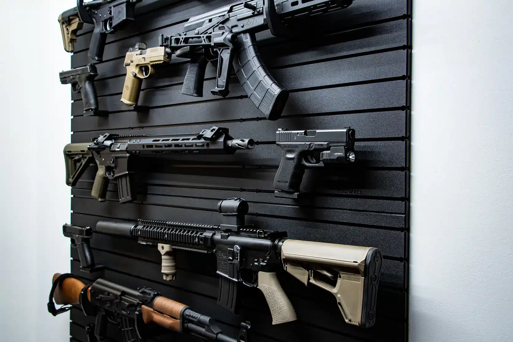 ModWall 9 Gun Combo Pack Side-angle view of the ModWall 9 Gun Combo system, highlighting the low-profile depth of the black panels and the secure mounting of diverse firearms and handguns.