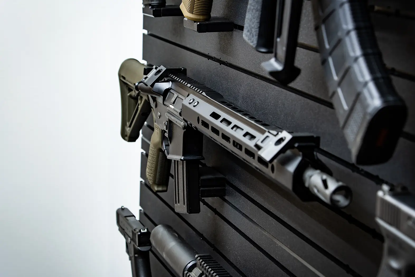 ModWall 9 Gun Combo Pack A detailed, angled view of a black tactical rifle resting securely on a ModWall horizontal rack.