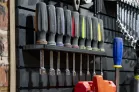 ModWall Small Driver Rack A Small Driver Rack holding a row of colorful screwdrivers on top and socket extensions hanging beneath on a black HDPE panel