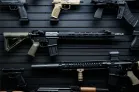 ModWall 9 Gun Combo Pack A detailed view of several firearms, including AR-15 rifles and handguns, mounted on a black ModWall panel to demonstrate the visual pleasure of the ModWall 9 Gun Combo Pack.