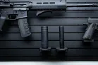 ModWall Suppressor Holder A closeup view of multiple silencers added onto an existing ModWall panel system, also featuring a mounted rifle and handgun.