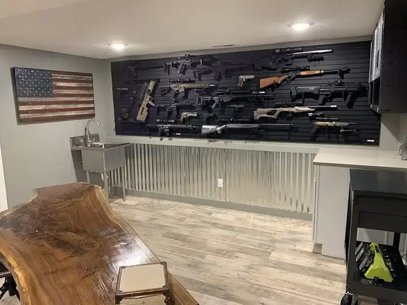 ModWall Panels (48″Wx22″H) A large-scale basement gun room featuring the pre-built ModWall Patriot Pack used to horizontally display an extensive collection of rifles and handguns.