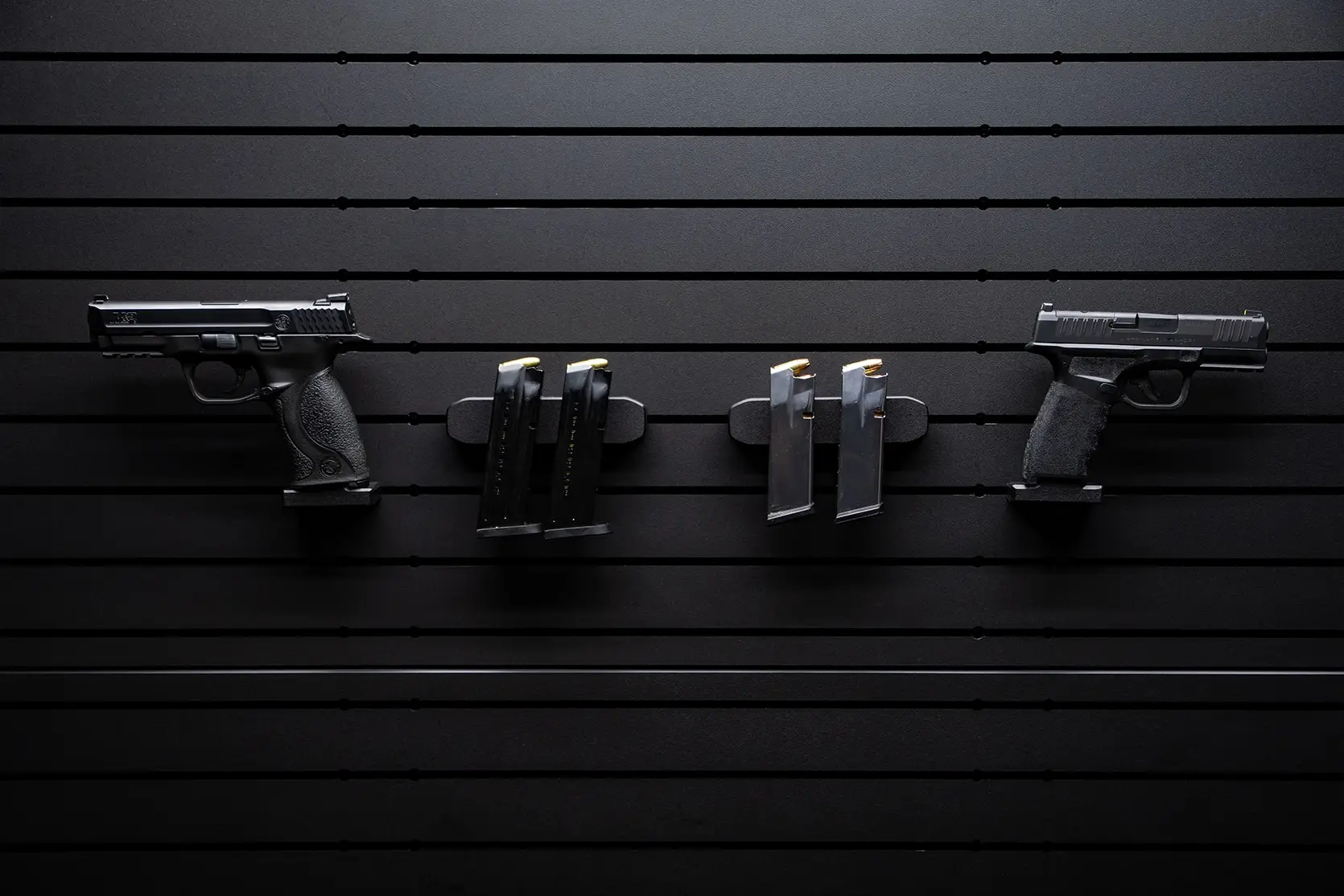 ModWall Hide-A-Mags Magnet accessory mounted on ModWall panel holding a handgun