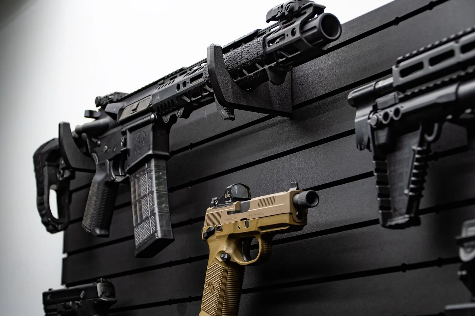 ModWall Horizontal wall mount gun rack holding several firearms
