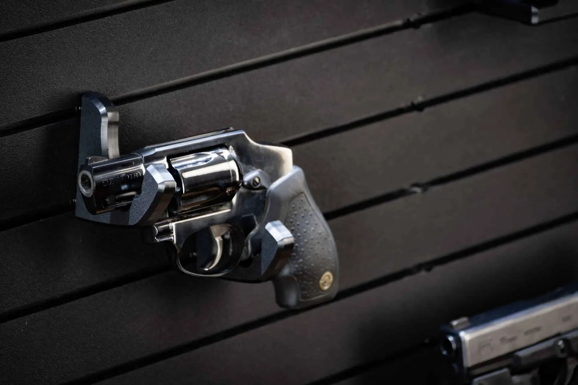 ModWall Handgun Rack Wall mounted handgun rack securing a full size pistol on panel.