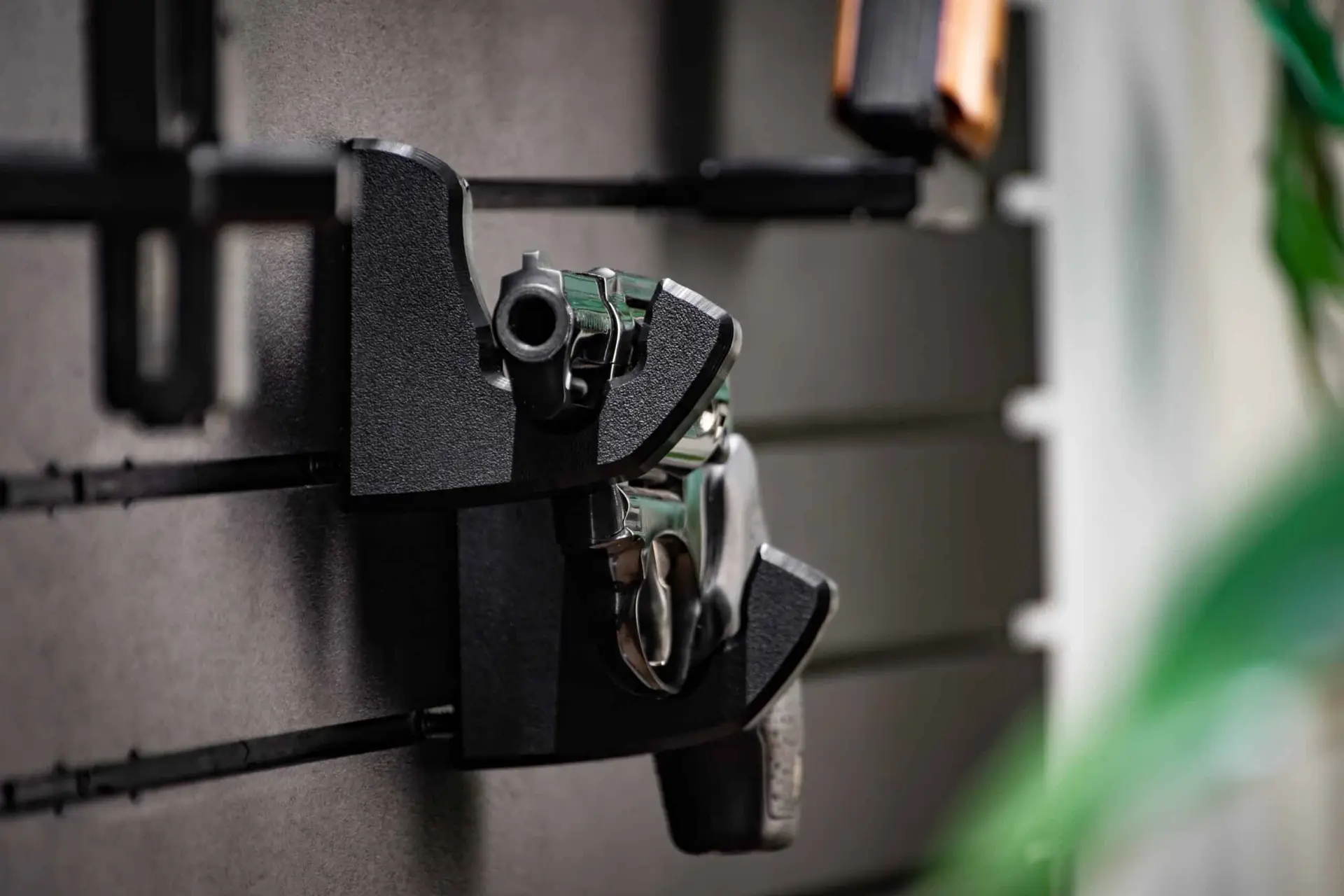 ModWall Handgun Rack Wall mounted handgun rack securing a full size pistol on panel.