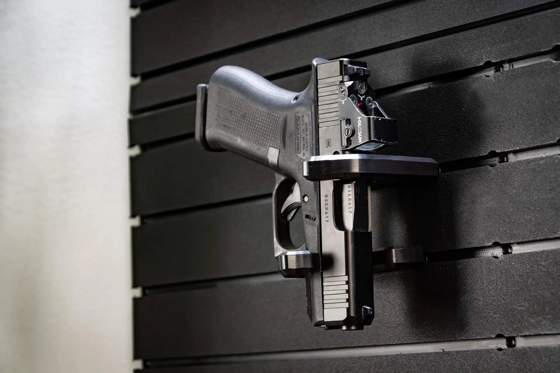 ModWall Handgun Rack A mounted handgun holder securing a full size pistol on panel vertically, showcasing the product's modularity and flexibility in fitting virtually all handgun sizes.