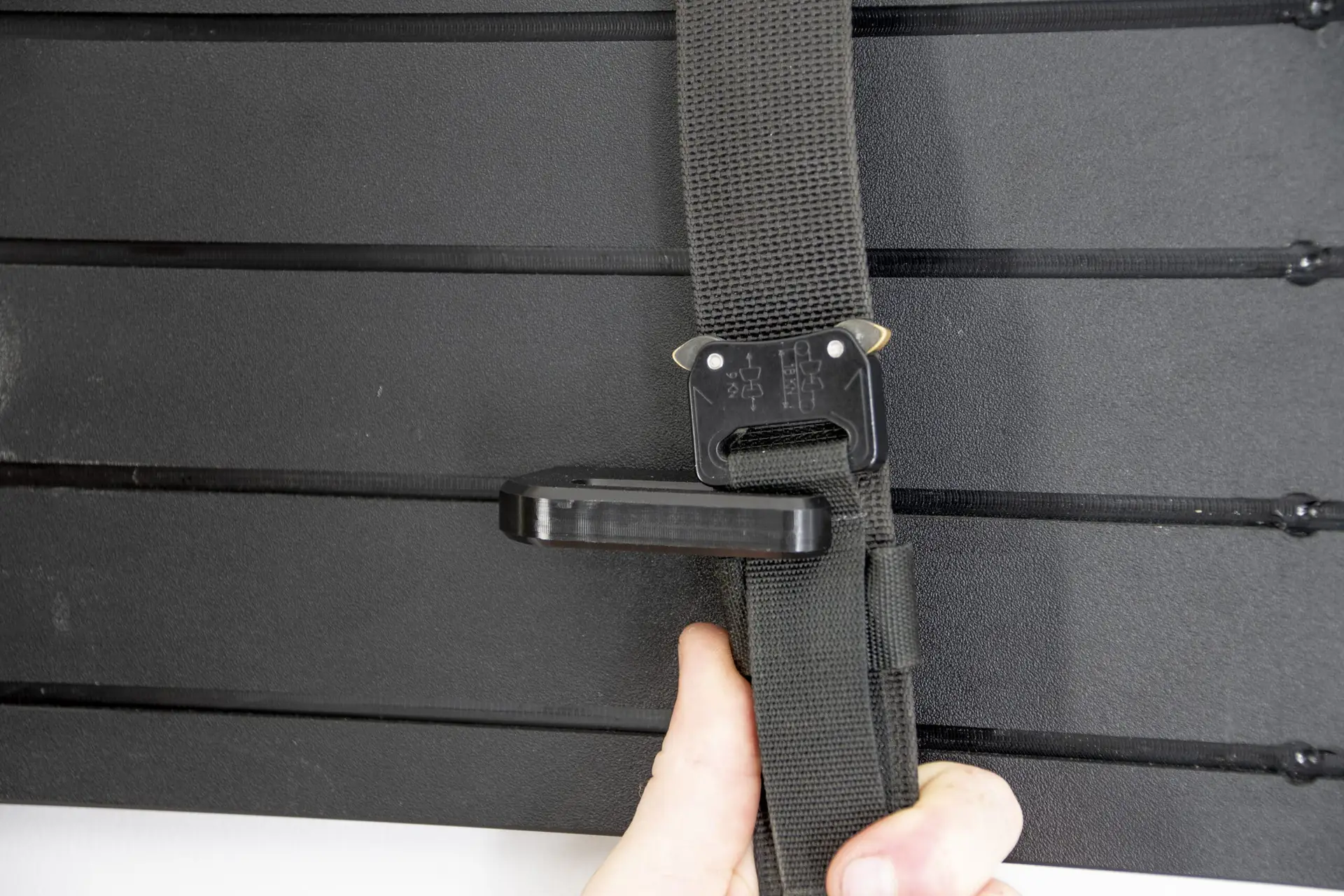 ModWall Tactical Belt Mount A person taking off a duty belt off the tactical belt mount.