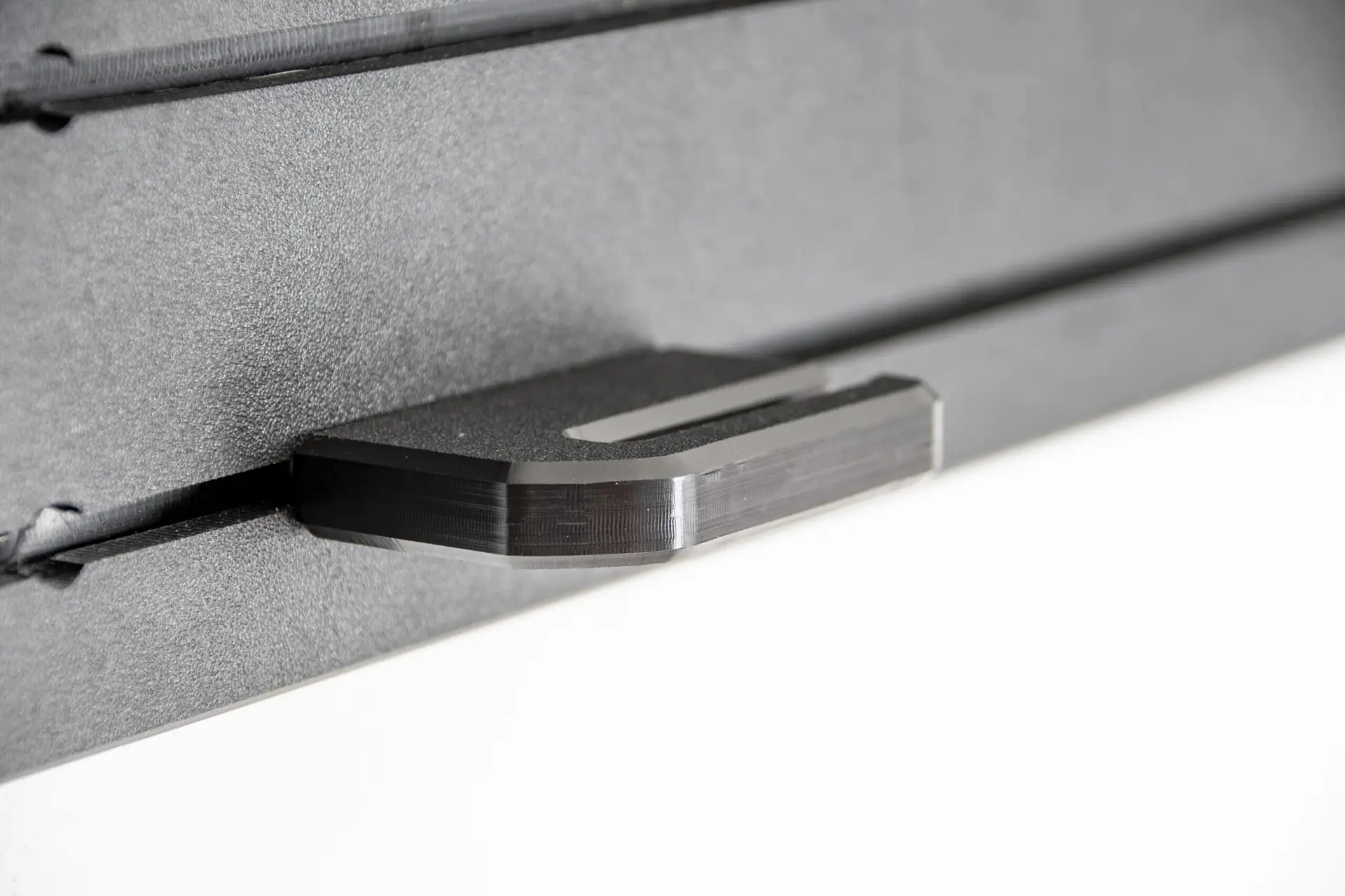 ModWall Tactical Belt Mount A closeup view of the attachment against the ModWall panel, showcasing its sleek, slim profile.