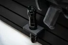 ModWall 9 Gun Combo Pack Close-up of a black tactical flashlight secured in a ModWall flashlight holder on a ModWall panel.