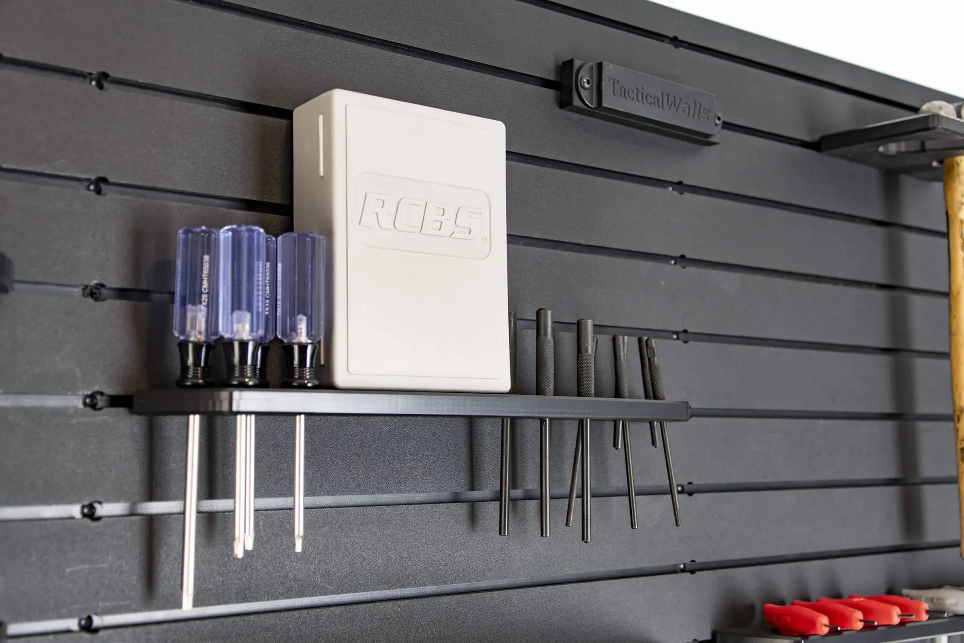 ModWall Punch Set Holder A tool wall organization system storing small screwdrivers and other small hand tools against a black, modular panel.