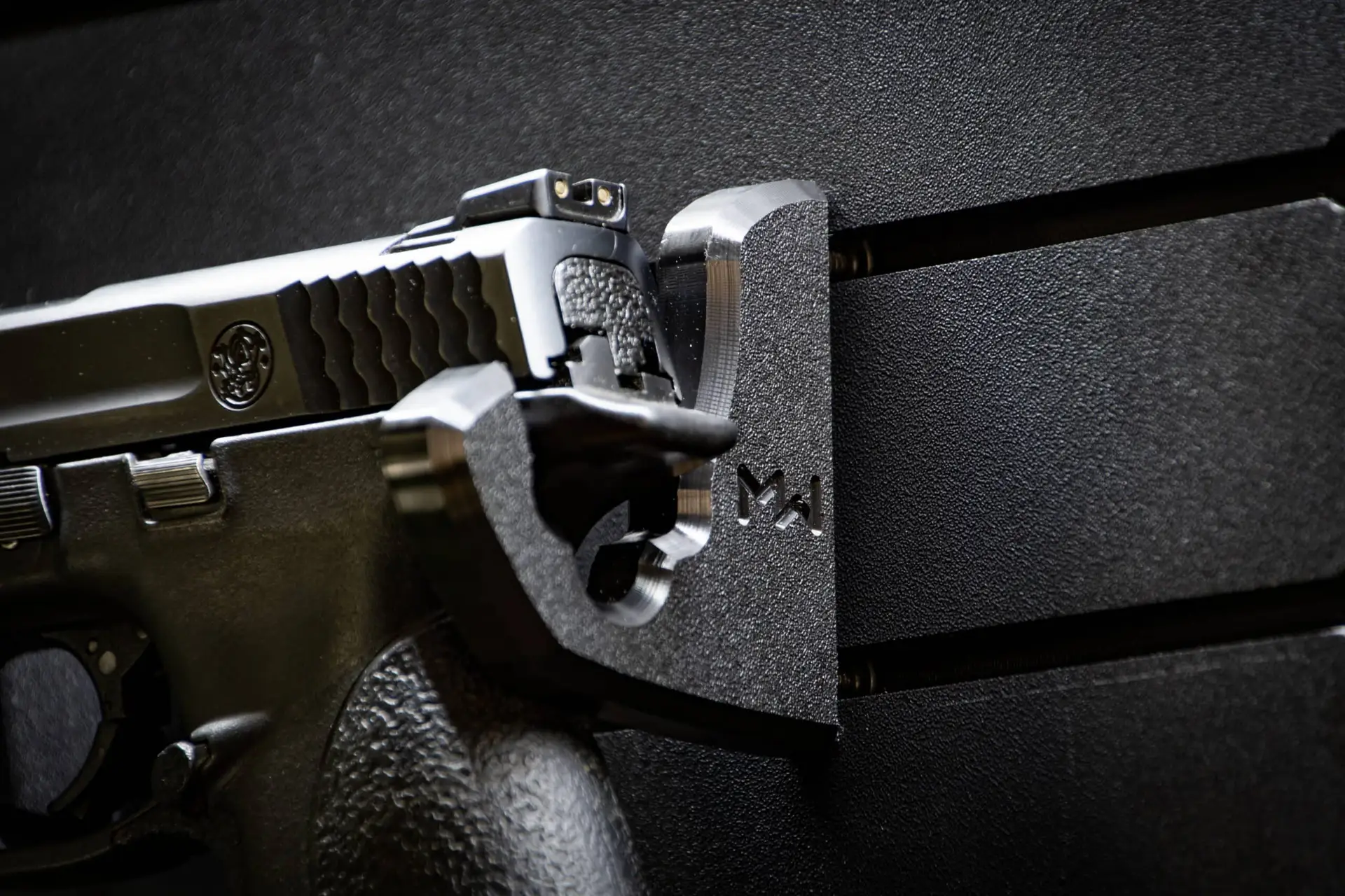 ModWall Handgun Rack Wall mounted handgun rack securing a full size pistol on panel.