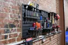 ModWall Project Package ModWall Project Package mounted on a brick wall displaying screwdrivers, wrenches, air tools, power drills, and storage bins on a black HDPE panel for modular garage tool storage.