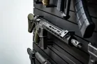 ModWall 9 Gun Combo Pack A detailed, angled view of a black tactical rifle resting securely on a ModWall horizontal rack.