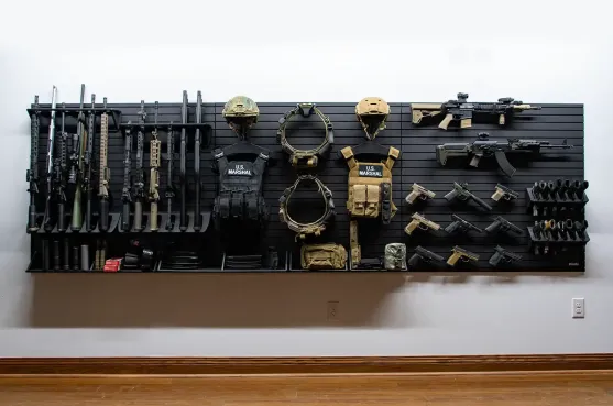 Yellowstone Marshals Arsenal Package ModWall Yellowstone Marshals Arsenal Package featuring a comprehensive tactical wall display with rifles, shotguns, pistols, plate carriers, and helmets on a modular slatwall system.