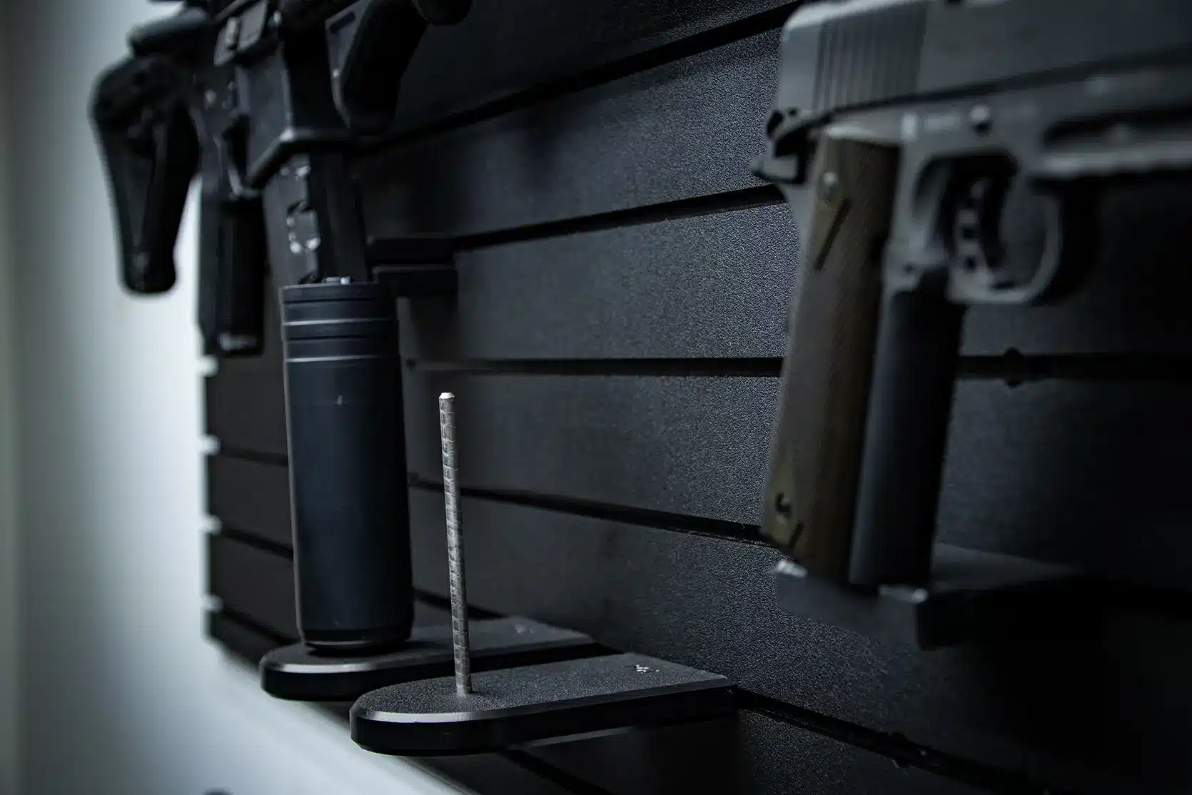 ModWall Suppressor Holder A closeup, angled view of an empty suppressor holder with a metallic vertical rod.