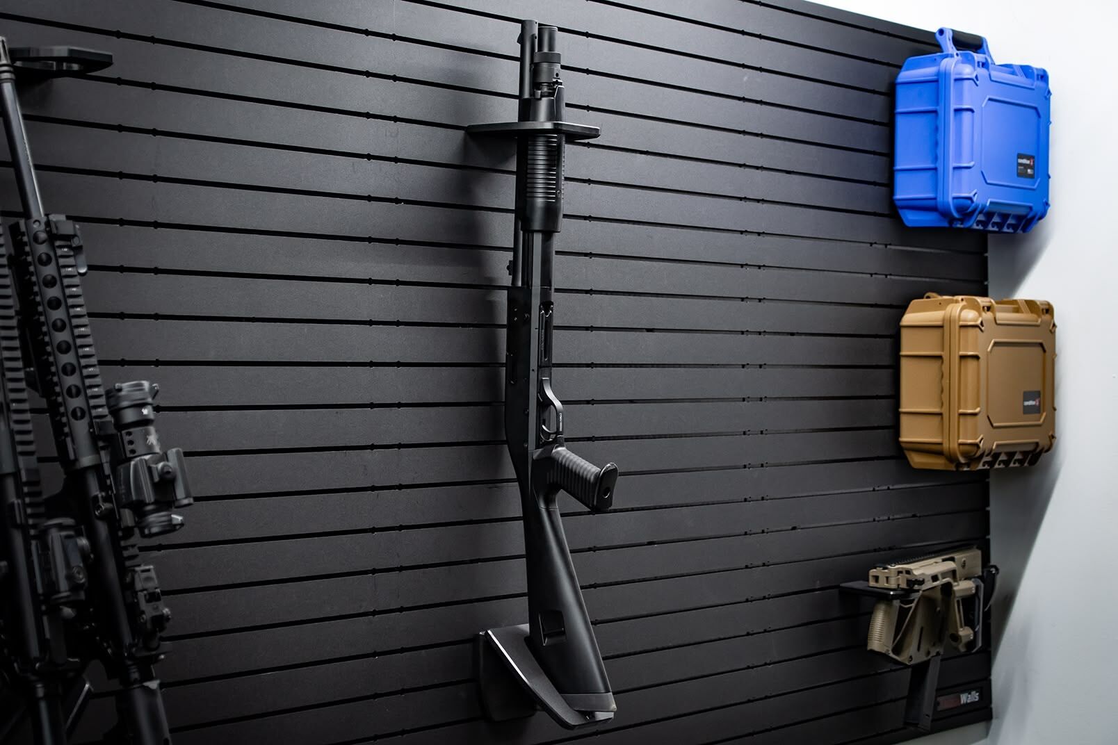 ModWall Vertical One Rifle Rack A tactical shotgun mounted vertically on a ModWall panel system.