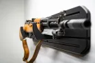 MidMod Rifle Display Package An angled closeup of a firearm mounted to a black ModWall board.