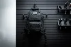 The ModWall Hook A black back page stored on a panel beside multi-pistol hangers, creating a seamless setup.