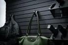 The ModWall Hook A purse being hung on the wall against a panel.