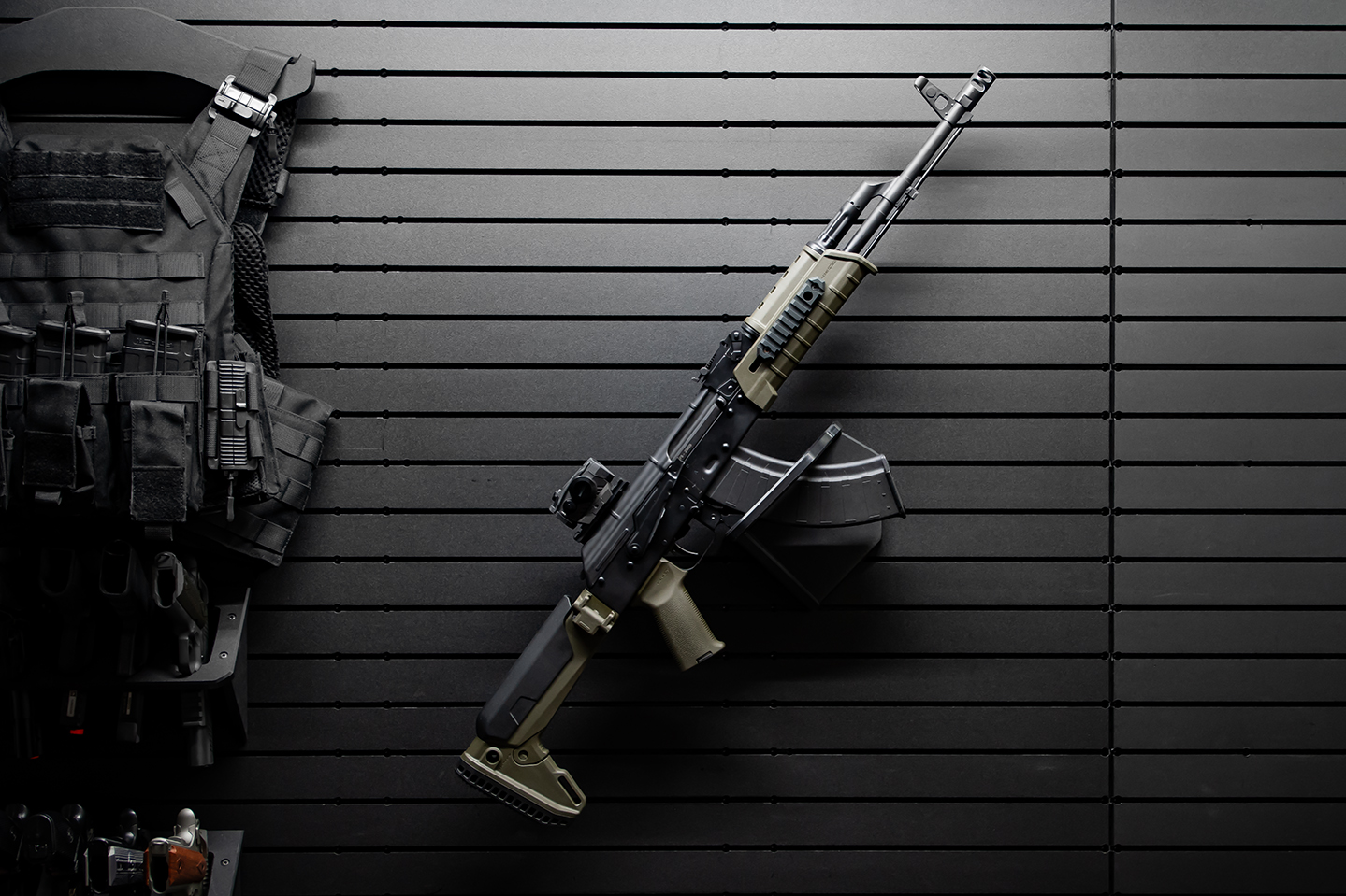 ModWall Sideways Vertical Rifle Rack A single rifle vertically mounted on a ModWall panel by its magazine.