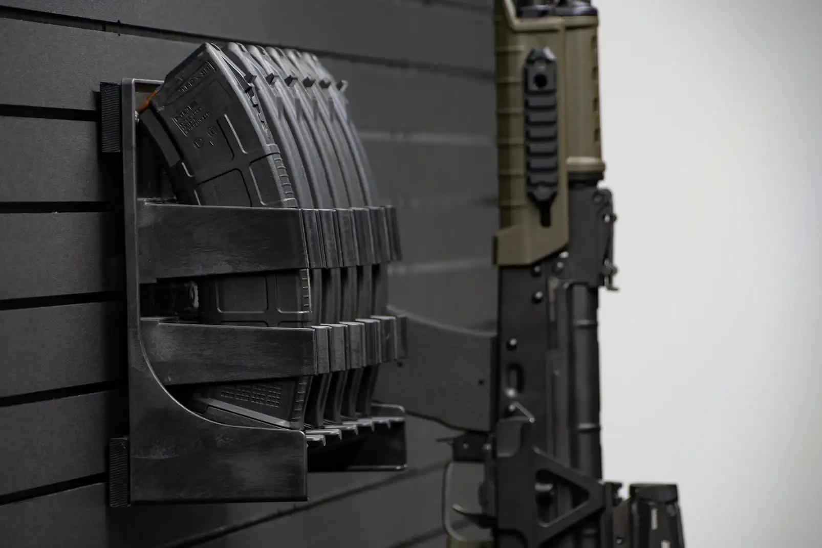 ModWall Mag Racks A rack of AK-47 magazines mounted on the wall alongside an AK-47 rifle hung vertically.