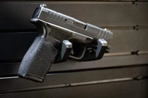 ModWall Handgun Rack Wall mounted handgun rack securing a full size pistol on panel.