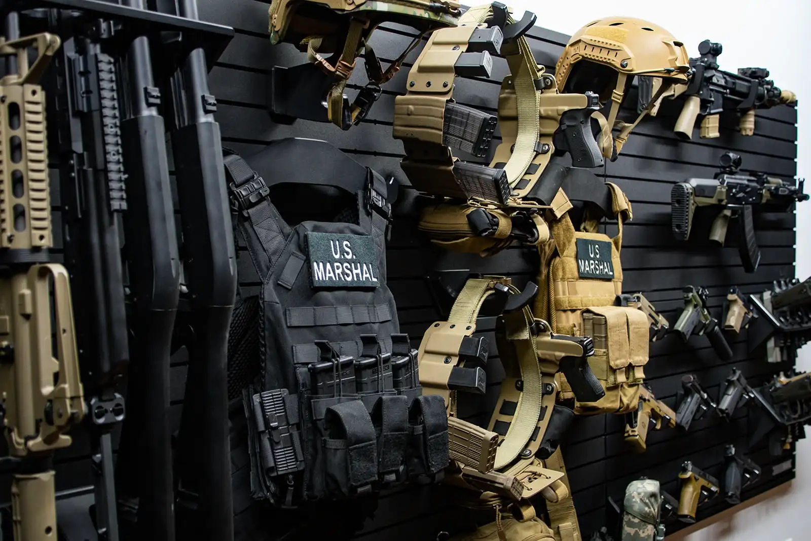 Yellowstone Marshals Arsenal Package Various firearms and tactical gears mounted on the modular wall system of the ModWall Yellowstone Marshals Arsenal Package.